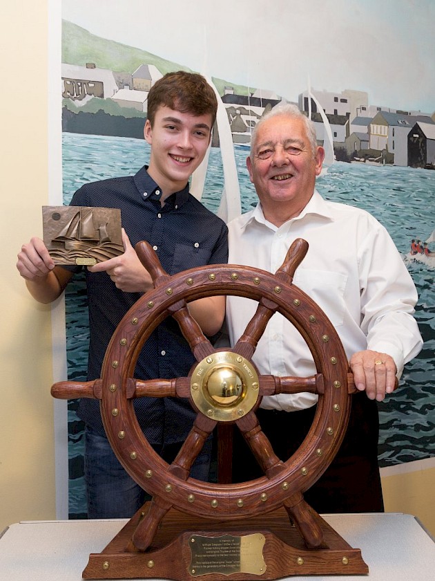 Left, Theo Irvine from Burra being presented the Vevoe Trophy by Peter Malcomson, Chairman of Shetland Tall Ships Company Ltd.