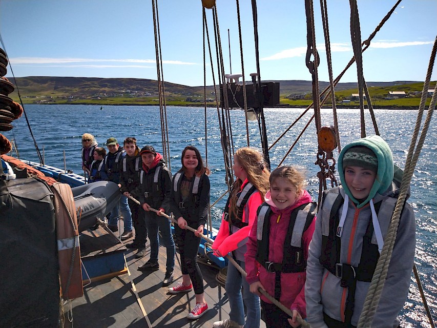 Brae High School pupils waiting to raise sails