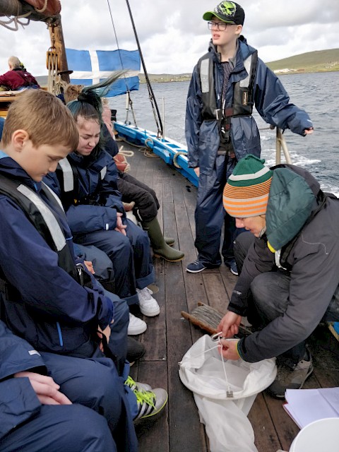 Taking water samples on board Swan with school pupils