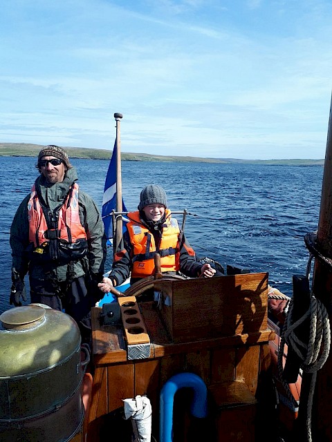 Happyhansel School half day sail - pupil enjoys his turn at the helm