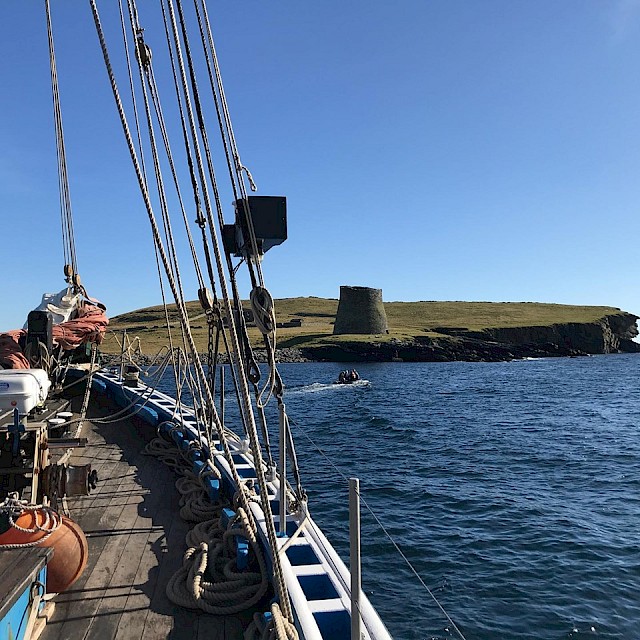 Passengers going ashore in the dinghy to visit the Iron Age Broch on Mousa, Shetland