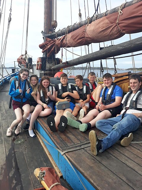 One Step Beyond group stopping for a group shot on deck