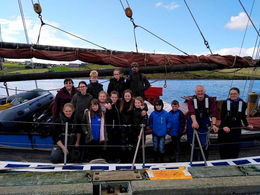 Swan Crew with pupils from Mid Yell School