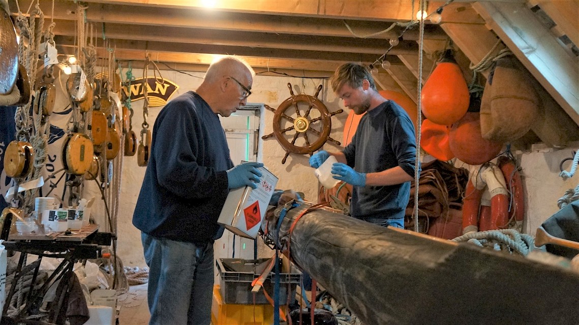 Brian Wishart and Alec Moncrieff working on the final stages of applying epoxy resin to the inserts in the Bowsprit