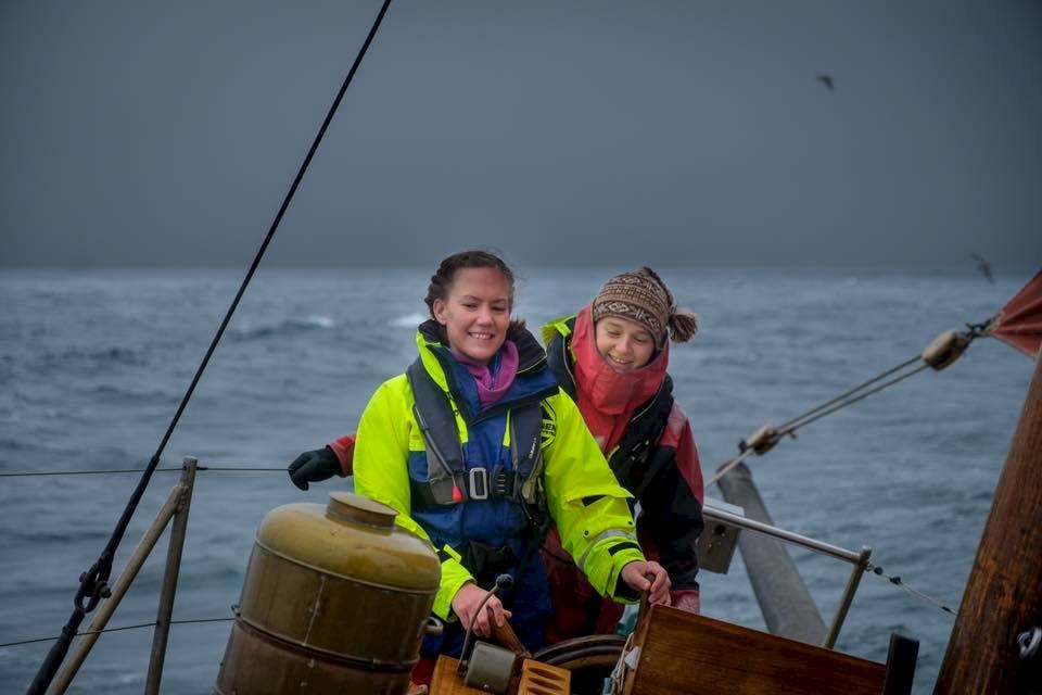 Overseeing a passenger taking the helm for the first time