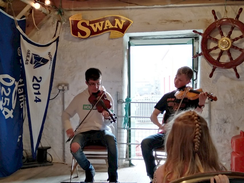 Ewan playing in the Swan Boat Store with Magnus, as part of Shetland Boat Week 2019