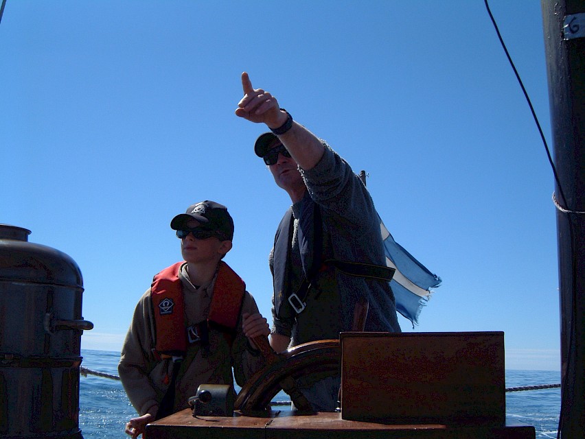 At the helm with a school pupil