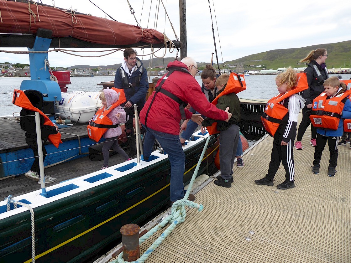 Brian and Ailish help the children aboard the Swan