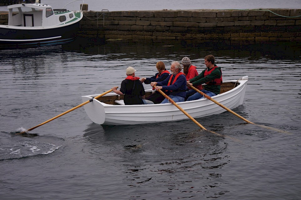 Volunteers rowing the Swan Smaa Boat in Hay Dock, Lerwick, in 2015