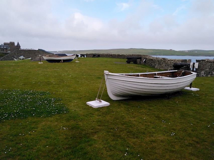 The Swan Smaa Boat pictured with other boats in the exhibition at Fort Charlotte