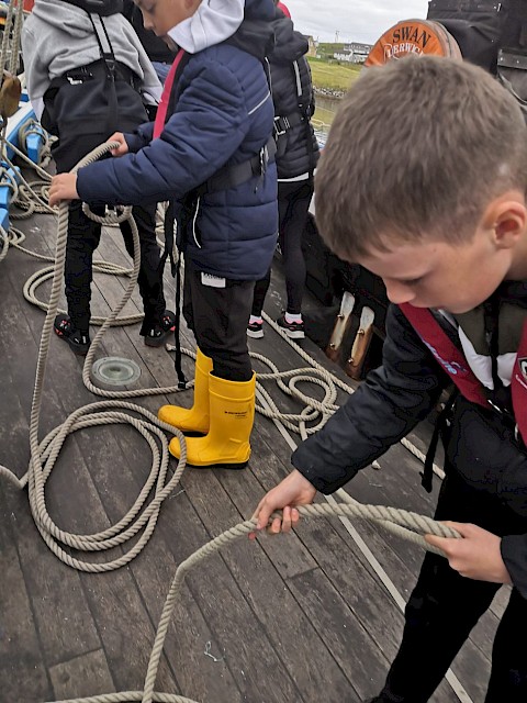 Pupils practice coiling ropes on deck