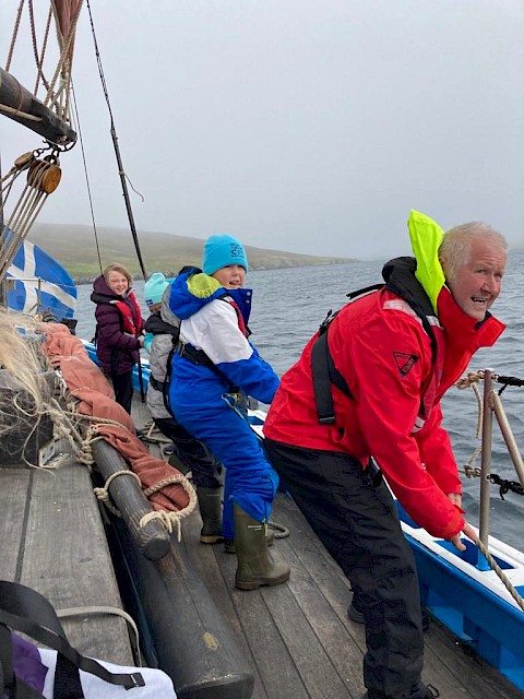 Primary 6 pupils haul the lines with Swan Trust volunteer Ian Nicolson