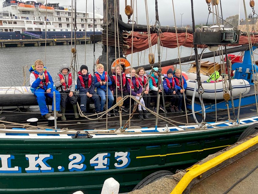 Primary 6 pupils pose for a photo following their trip