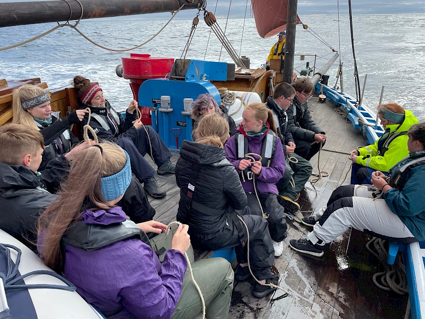 Youth Sail Trainees learning to tie knots during a day trip in 2021