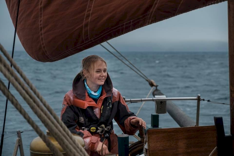 Maggie at the helm in 2019 during a trip around Shetland. Image credit: James Wood