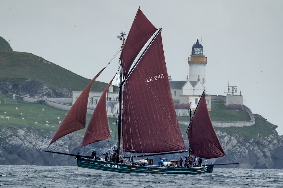 The Swan with all 5 sails up, passing Bressay Lighthouse. Image: Maurice Henderson