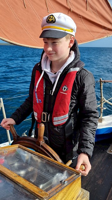 Baltasound pupil taking their turn at the helm