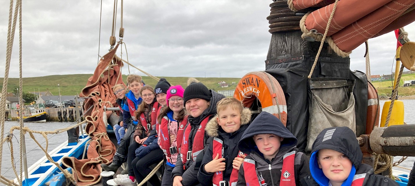 Group of Mid Yell School pupils aboard the Swan