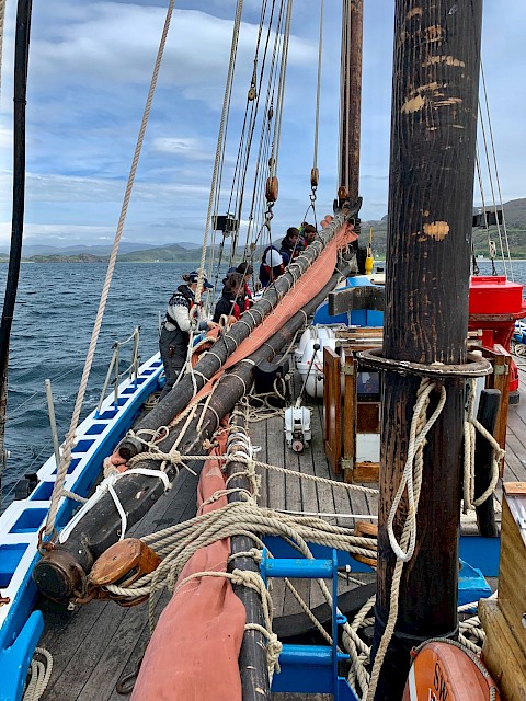 Trainees learning how to stow the main sail