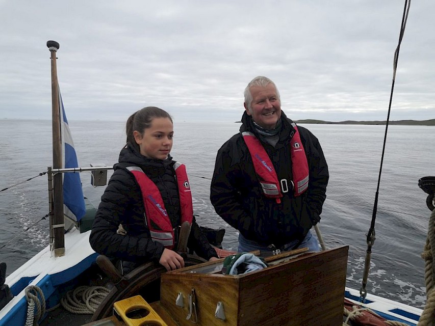 Ian at the helm with a school pupil - 2021