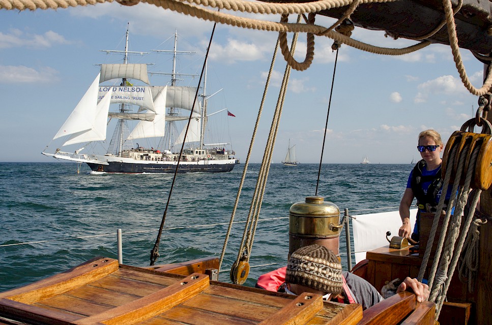 Swan Skipper, Maggie Adamson, at the helm during a previous Tall Ships Race. Image: Leanne Fischler