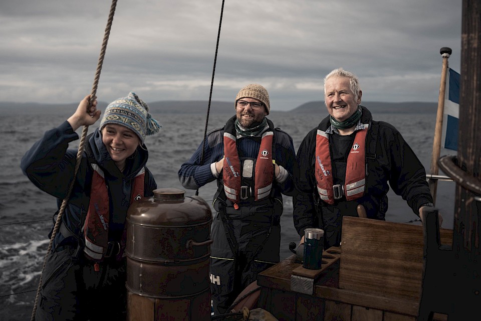 Swan Skipper, Maggie Adamson, with volunteer crew members, Shayne McLeod and Ian Nicolson, enjoying watching the activity aboard, photographed by @kletspoot