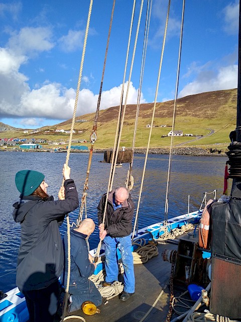 First...blocks and running rigging being sent aloft