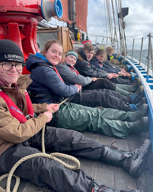 Trainees pose for a quick snap whilst working with the lines on deck